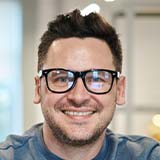 PSSNET IT Consultant – Managed Services Expert Toronto Smiling professional working on a laptop – PSSNET IT consultant and managed services Toronto